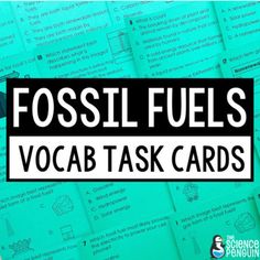 the words fossil fuels and vocab task cards are in front of a pile of papers