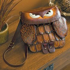 an owl purse sitting on top of a wooden table