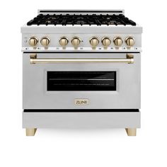 a white stove with gold knobs on it's burners and two oven doors