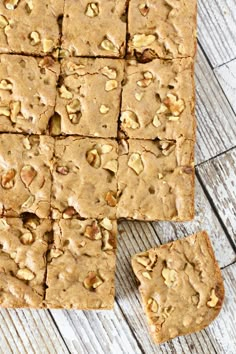 peanut butter bars cut into squares on top of a wooden table