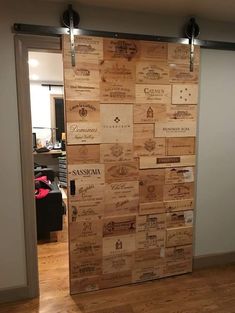 a door made out of wine corks in a room with wooden floors and walls