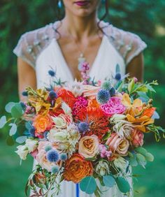 a woman holding a bouquet of flowers in her hands