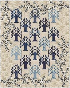 a quilted wall hanging with blue and white designs