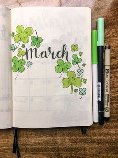 an open notebook with shamrocks and the word march written in cursive writing