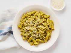 a white bowl filled with pasta on top of a table