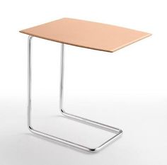 a small wooden table sitting on top of a white floor next to a metal frame