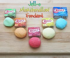 several different colored candies on a cutting board