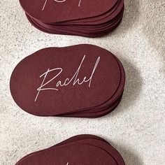 three pairs of shoes with the words rachel written in white ink on them, sitting next to each other