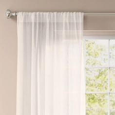 a white curtain hanging on the side of a window