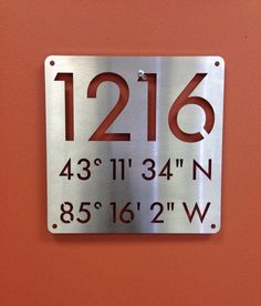 a metal sign that says 216 and has the date on it, as well as an arrow