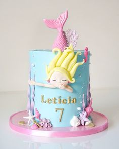 a birthday cake with a little mermaid on the top and under the words lettich 7