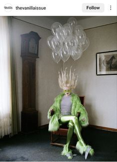 a woman sitting in a chair with balloons floating from her head and hands behind her back