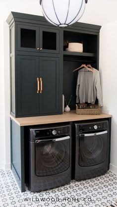 a washer and dryer in a laundry room next to a cabinet with an open door