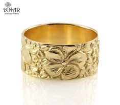 a gold ring with flowers and leaves on it