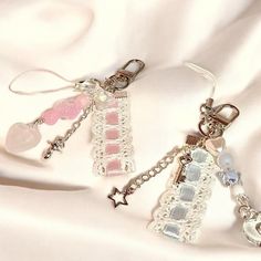 two charms are sitting on a white cloth