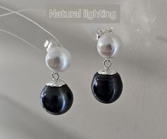 These classic earrings feature two lagoon-hued black or dark peacock greenTahitian pearls (which may have a few very small natural growth dots, though not noticeable) and two aurora white freshwater pearls (with flawless, mirror-like surfaces). The two colors create a striking contrast, exuding a sense of calmness while showcasing a bold personality. The design is simple yet elegant, making these earrings a perfect choice for both everyday wear and special occasions.（Because each pearl's shape i Pearl Earring Studs, Bold Personality, Tahitian Pearl Earrings, Black Stud Earrings, Classic Earrings, Earring Studs, Pearl Earring, June Birthstone, White Freshwater Pearl