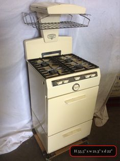 an old fashioned stove with two burners on it's sides and a shelf over the top