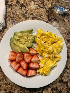 an omelet, strawberries and avocado on a plate