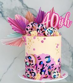 a birthday cake decorated with pink and blue decorations