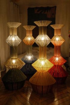 many different colored lamps sitting on top of a wooden floor