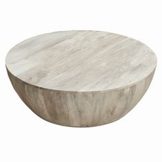 a round wooden table sitting on top of a white floor