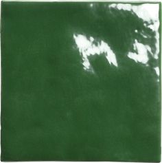 a green square with white clouds in the sky on it's sides and bottom