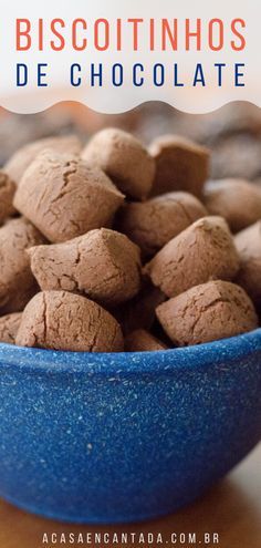 a blue bowl filled with chocolate pieces on top of a table