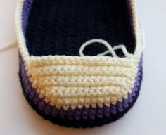 a crocheted loafer sitting on top of a white table