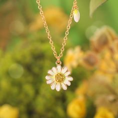 Step into a world of whispered secrets and timeless charm with the Daisy Pendant Necklace, part of our Nature Jewelry collection. Meticulously handcrafted in 18K gold-plated brass, the delicate enamel daisy sparkles with cubic zirconia accents, a nod to the Victorian Era’s love for symbolism. Back then, daisies weren’t just flowers—they represented innocence, loyalty, and the sacred duty of keeping confidences. Gifting a daisy meant, in the silent language of flowers, “your secret is safe with m Gold Plated Flower Shaped Jewelry For Gifts, Dainty Flower-shaped Enamel Jewelry, Handmade Gold Enamel Necklaces, Delicate Yellow Gold Charms Jewelry, Dainty Gold Plated Flower Shaped Jewelry, Dainty Gold Plated Flower Jewelry, Yellow Gold Enamel Jewelry With Flower Charm, Whimsical White Pendant Jewelry, Delicate Yellow Gold Jewelry With Charms