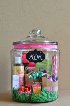 a jar filled with lots of different types of items and the words mother's day in a jar