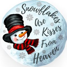 a snowman with a hat and scarf on it's face is shown in front of the words, snowflakes are kisses from heaven