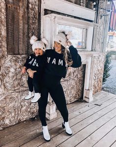 two women in matching outfits posing for the camera