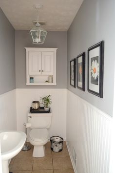 a white toilet sitting in a bathroom next to a sink