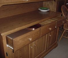 a wooden cabinet with a bowl on top of it