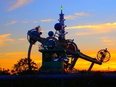 an amusement park with a roller coaster at sunset