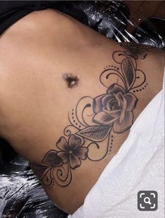 a woman with a rose tattoo on her stomach