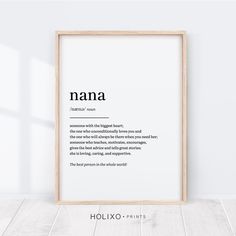 a framed poster with the words mommy in black and white, on a wooden floor