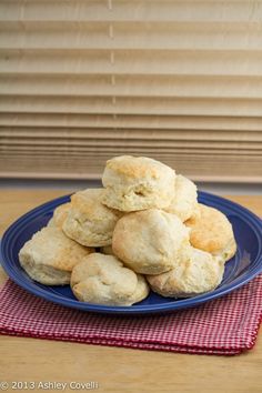 a blue plate filled with biscuits on top of a table