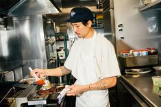 a man standing in a kitchen preparing food