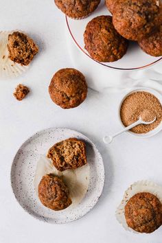 some muffins are on a plate next to other muffins