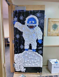 a door decorated with snowflakes and an image of a monster in the middle