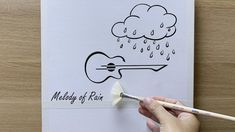 a hand holding a paintbrush and drawing on paper with the words medley of rain