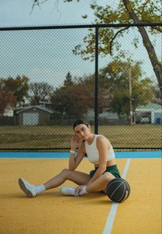 a woman is sitting on the tennis court