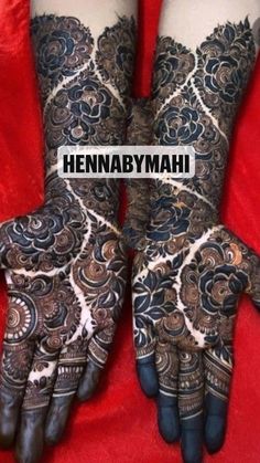 two hands with henna tattoos on them