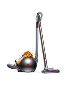 a silver and red vacuum is next to a gray ball that has been placed on the floor