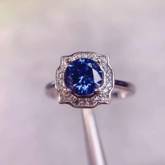 This breathtaking ring features a 1 ct royal blue moissanite, known for its striking color and exceptional brilliance. The vibrant blue stone is expertly cut to enhance its sparkle, making it a captivating centerpiece. Key Features: * Stone - 1 CT blue moissanite stone * Metal - 925 Sterling Silver * Stone Size - 6.5x6.5 mm * Total Carat Weight - 1 CT Ideal for engagements, anniversaries, or as a standout piece in any jewelry collection, this royal blue moissanite ring combines elegance with a modern twist. Whether you prefer a classic or contemporary look, this ring is sure to make a lasting impression. Blue Moissanite, Ring Moissanite, Vibrant Blue, Moissanite Ring, Moissanite Rings, Blue Stone, Fine Silver, Rings Statement, Statement Rings