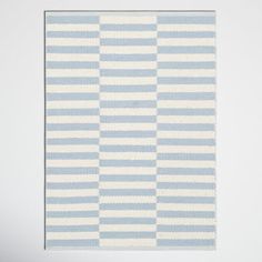 a blue and white striped rug hanging on a wall