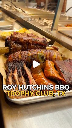 the tray is full of ribs and other meats on display for people to see