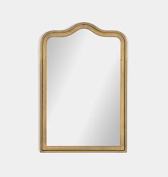 a gold framed mirror with an arched frame and wood trimmings on the edges