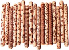 a row of wooden sticks with designs painted on the top and bottom, all lined up in rows